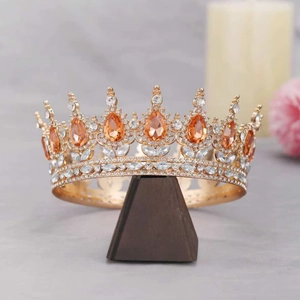 Macro shot of gold alloy bridal crown with orange teardrop crystals and white rhinestones