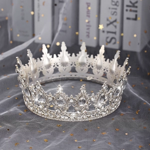 Close-up of silver bridal crown with intricate rhinestone patterns on star tulle