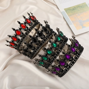 Detailed view of Gothic rhinestone tiaras with red, green, purple and black gemstones