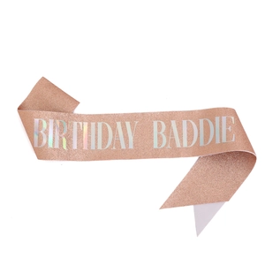 Sparkling pink glitter sash featuring holographic Birthday Baddie text for parties