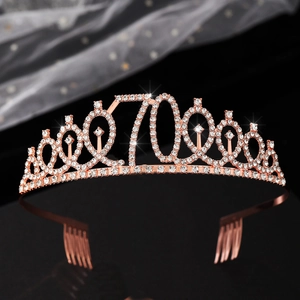 Close-up of rose gold 70th birthday crown with shimmering rhinestones and hair combs