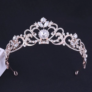 Macro shot of rose gold bridal crown with floral swirls and shimmering rhinestones