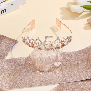 Detail of rose gold 50th birthday crown and glitter sash set for celebration events