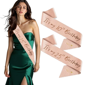 Close-up of rose gold glitter birthday sash with black text and safety pin accessory
