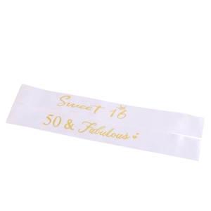 Detail of white satin birthday sashes with gold Sweet 16 and 50 & Fabulous lettering