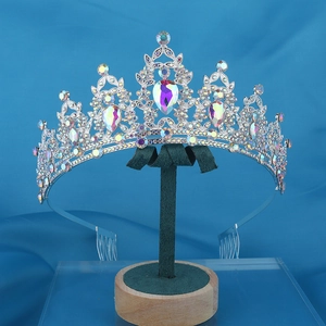 Elegant silver bridal tiara with colorful AB rhinestones on a green velvet stand
