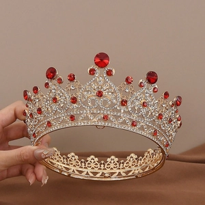 Detailed close-up of a vintage golden bridal crown featuring large red rubies and crystals