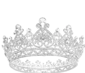 Macro detail of luxury silver tiara with intricate heart cutouts and sparkling rhinestones