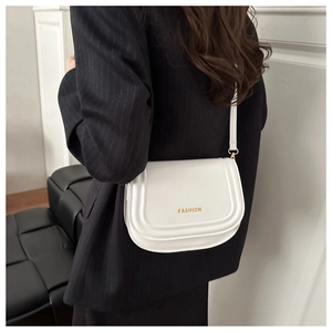 Side view of a white semi-circular crossbody bag with golden FASHION lettering