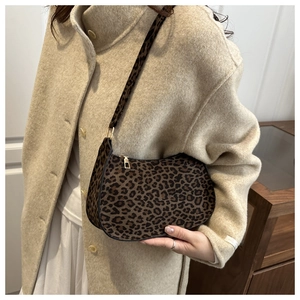 Detailed close-up of leopard print shoulder bag with soft plush texture and gold zipper