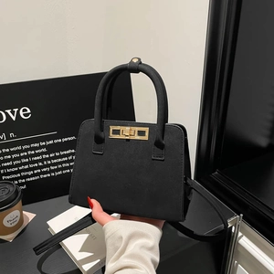 French style matte suede Kelly bag in black with gold metal lock and shoulder strap
