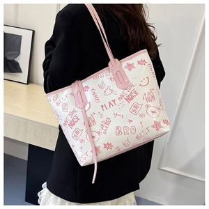 Detail of white tote bag with pink graffiti bear prints and leather trim for women