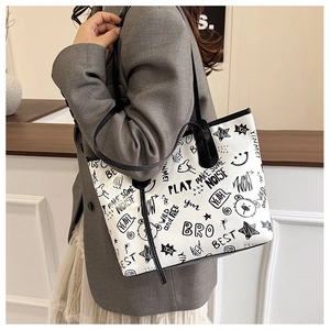 Detailed view of the large white tote bag featuring black street style graffiti and icons