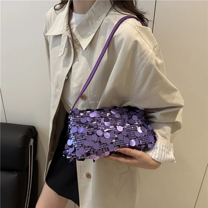 Chic purple sequined baguette bag for women with shoulder strap on a fashion model