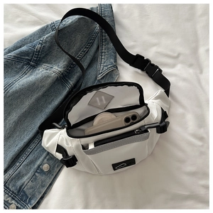 Detailed interior of a white nylon chest bag showing large capacity for phone and cosmetics