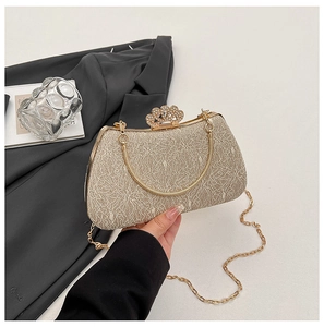 Close-up of champagne sequin evening bag with crown rhinestone clasp and gold chain