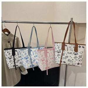 Close-up showing colorful graffiti prints and durable handles on the large tote bag