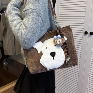 Brown corduroy tote bag with white plush dog design and chain strap on shoulder