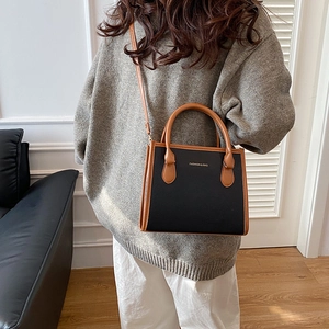 Fashion contrast tote bag with black lychee leather and brown handles for daily use