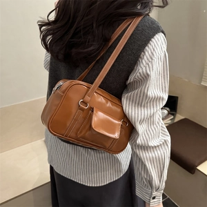 Vintage brown PU leather shoulder bag with front pocket and dual straps on model