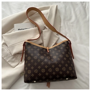 Detailed view of vintage monogram bucket bag with leather trim and metal base studs