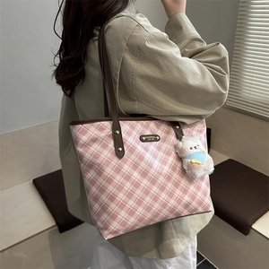 Pink checkered canvas tote bag with brown leather straps and cute plush bear accessory