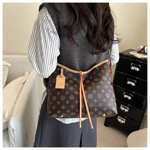 Detail of vintage monogram tote bag showing large capacity and drawstring design on shoulder
