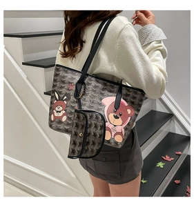 Close-up of cartoon bear prints and geometric patterns on a large tote bag with strap