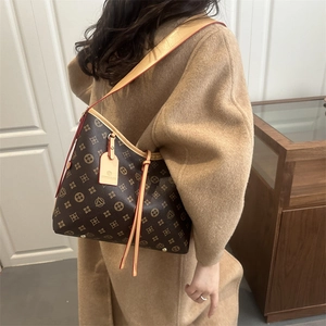 Classic monogram bucket bag with leather trim and drawstring in a minimalist setting