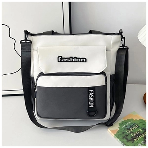 Detailed view of the multi-pocket structure and canvas texture on the dual-tone school tote bag