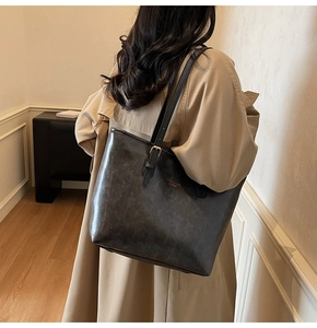 Minimalist large leather tote bag shown on model for daily commuting fashion look