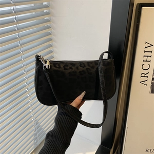 Elegant black leopard print baguette shoulder bag with silver hardware and slim strap