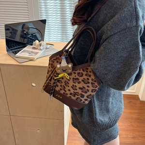 Fashionable leopard print bucket tote bag with leather handles and J&H logo charm