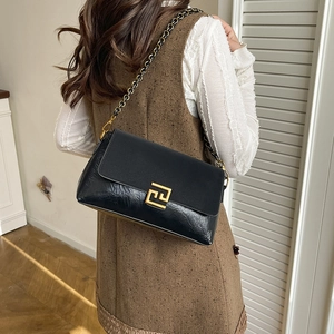 Fashionable black faux leather crossbody bag with square gold buckle and chain strap