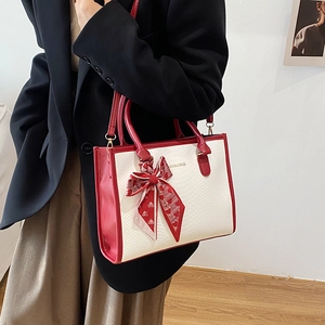 Elegant red and white color-block handbag with snake skin texture and silk scarf handle