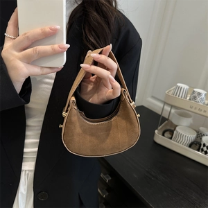 Chic brown faux suede half-moon mini handbag with leather handle and zipper closure