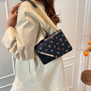 Chic black shoulder bag with pink bow floral print and gold chain strap for women