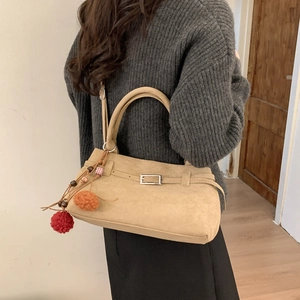Suede tote bag in camel brown with metal buckle and colorful plush ball charm pendant