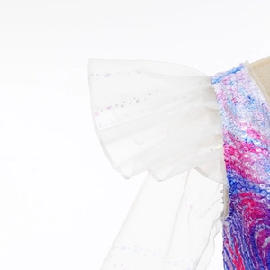 Close-up of organza ruffled sleeves and colorful sequin details on a children's dress