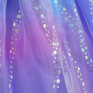 Detailed macro view of purple-blue gradient mesh tulle with sparkling silver sequins