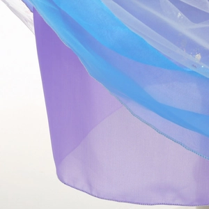 Close-up of layered light blue and lilac tulle fabric with detailed hem stitching