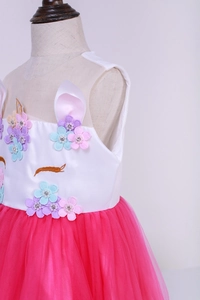 Detail of unicorn girl dress featuring handmade 3D flowers and vibrant pink tulle skirt