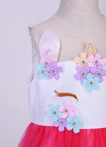 Detail of unicorn dress with 3D mesh flowers, pearls, and gold embroidery on bodice