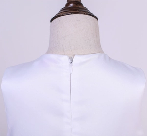 Detail view of the hidden back zipper on this white satin girls princess dress garment