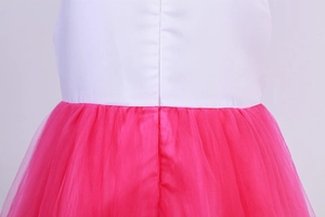 Detail of white satin bodice and layered pink tulle skirt with precise waist stitching