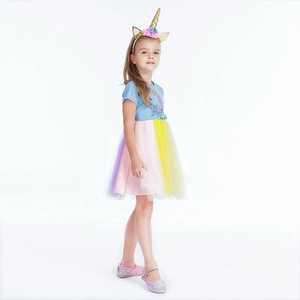 Detail of colorful rainbow tulle skirt and unicorn print on girls princess dress