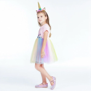 Close-up of pink unicorn dress with rainbow mesh skirt, headband and sequin shoes