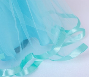 Gros plan sur l'ourlet en tulle bleu ciel avec finition élégante en ruban satiné