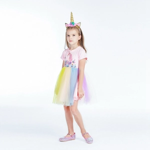 Detail of pink unicorn cotton bodice with rainbow tulle skirt and floral headpiece