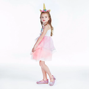 Close-up of pink tulle unicorn dress with floral headband and matching glitter shoes